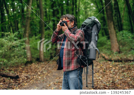 Hiking experience, senior man is in the forest at daytime 139245367