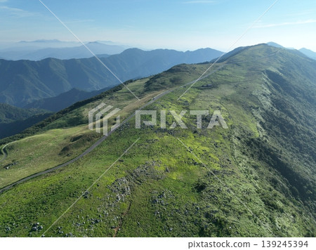 Drone aerial footage of the ridge roads and summer plateau scenery of the Shikoku Karst. Drone aerial footage of the ridge roads and summer plateau scenery of the Shikoku Karst. 139245394