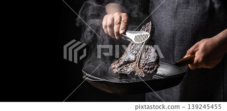Burnt steak as business failure metaphor with charred surface and smoke on dark background. copy space 139245455