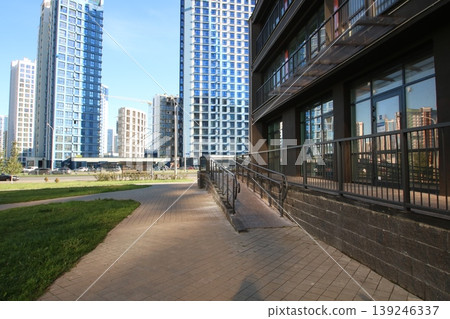 Elegant glass towers situated next to river enhanced by landscaped gardens and reflective windows Elegant glass towers situated next to river enhanced by landscaped gardens and reflective windows 139246337