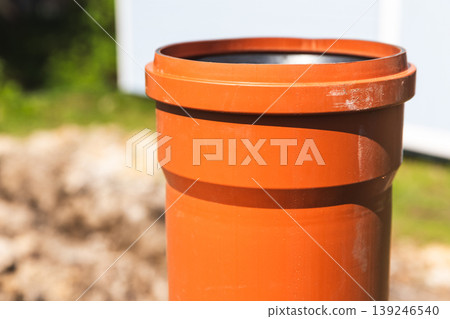 A detailed view of a snanding orange plastic pipe A detailed view of a snanding orange plastic pipe 139246540