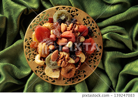 Assortment of dried tropical fruits, nuts and raisins. 139247083