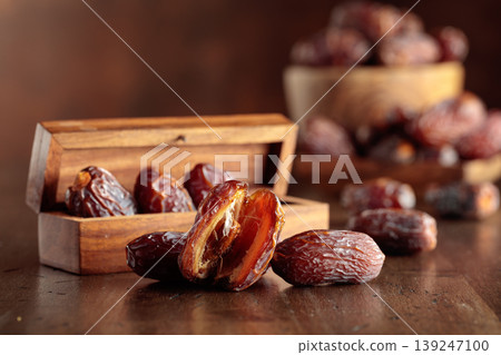 Dates fruit on an old wooden table. Dates fruit on an old wooden table. 139247100