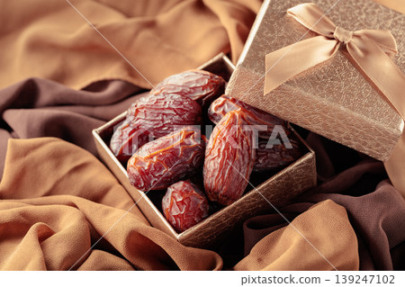 Dates fruits in golden gift box. Dates fruits in golden gift box. 139247102