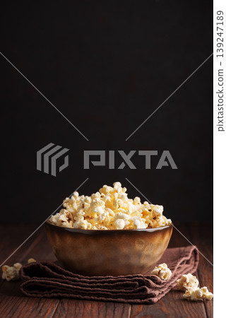 Popcorn Bowl on Dark Wooden Table Popcorn Bowl on Dark Wooden Table 139247189
