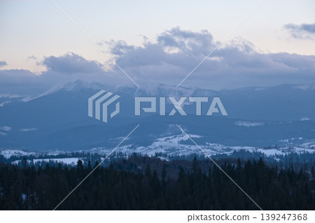Winter evening sunset mountains (Ukraine, Carpathians - mountain peaks scenery view from Yablunytsia Pass). Winter evening sunset mountains (Ukraine, Carpathians - mountain peaks scenery view from Yablunytsia Pass). 139247368