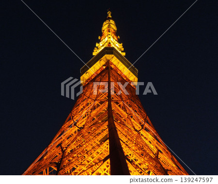 A symmetrical composition of Tokyo Tower lit up at night. A symmetrical composition of Tokyo Tower lit up at night. 139247597