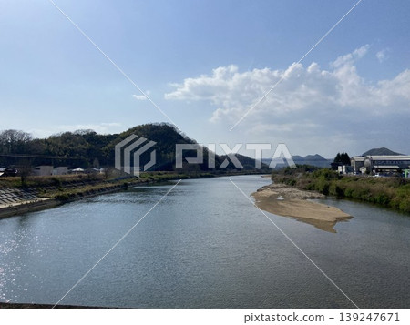 A tranquil river scene in Mihara City, Hiroshima Prefecture, showing the Numata River and a sandbar. 139247671