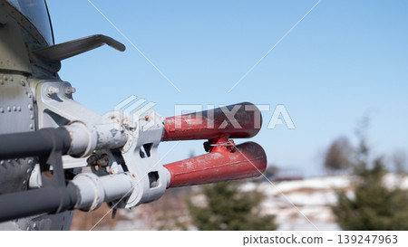 Closeup Aircraft Rocket Tips On Pylon, Weathered Red Paint, Exposed Mounting Hardware, Metal Fuselage Edge, Snowdusted Landscape, Clear Blue Sky, Shallow Depth Of Field, Maintenance Closeup Aircraft Rocket Tips On Pylon, Weathered Red Paint, Exposed Mounting Hardware, Metal Fuselage Edge, Snowdusted Landscape, Clear Blue Sky, Shallow Depth Of Field, Maintenance 139247963