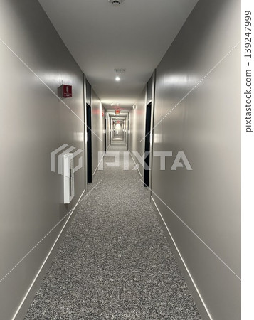 A simple and modern apartment hallway; a deep, linear space. A simple and modern apartment hallway; a deep, linear space. 139247999