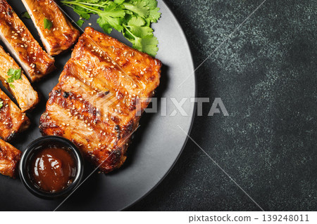Hot grilled spare ribs from a summer BBQ served on a plate with Hot grilled spare ribs from a summer BBQ served on a plate with 139248011