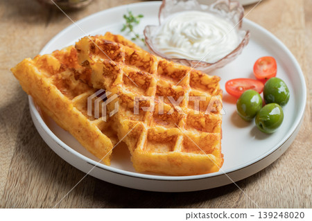 Crunchy waffle fries with sour cream dip served in a basket Crunchy waffle fries with sour cream dip served in a basket 139248020