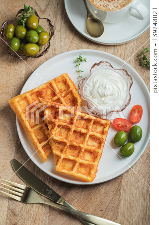 Crunchy waffle fries with sour cream dip served in a basket Crunchy waffle fries with sour cream dip served in a basket 139248021