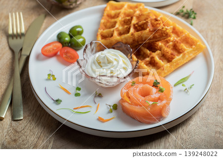 Crunchy waffle fries with sour cream dip served in a basket 139248022