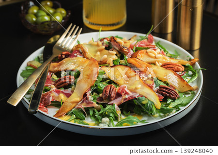 Salad with Pear, Arugula, Jamon, Blue Cheese and Blueberry, Delicious Fresh Salad Appetizer on Bright Background Salad with Pear, Arugula, Jamon, Blue Cheese and Blueberry, Delicious Fresh Salad Appetizer on Bright Background 139248040