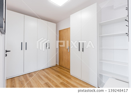 Modern hallway featuring white built in wardrobes and minimalist design Modern hallway featuring white built in wardrobes and minimalist design 139248417