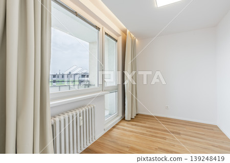 Empty room presenting minimalist interior design with window and hardwood floor Empty room presenting minimalist interior design with window and hardwood floor 139248419