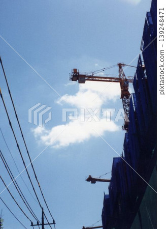 Construction Site with Cranes and Building Under Construction 139248471