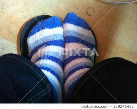 Feet in Striped Socks and Flip-Flops Feet in Striped Socks and Flip-Flops 139248482
