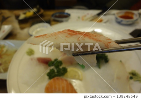 Crab Stick Sushi with Chopsticks Close-up Crab Stick Sushi with Chopsticks Close-up 139248549
