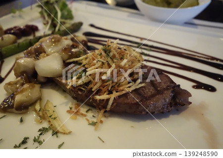 Gourmet Steak with Asparagus, Onions, and Crispy Toppings Gourmet Steak with Asparagus, Onions, and Crispy Toppings 139248590