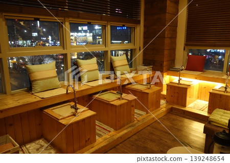 Cozy Nighttime Urban Interior with Wooden Benches and Sinks Cozy Nighttime Urban Interior with Wooden Benches and Sinks 139248654