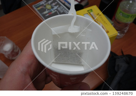 Tea Bag in Disposable Cup with Stirrer 139248670