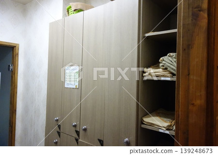 Locker Room Storage Cabinet with Folded Clothes Locker Room Storage Cabinet with Folded Clothes 139248673
