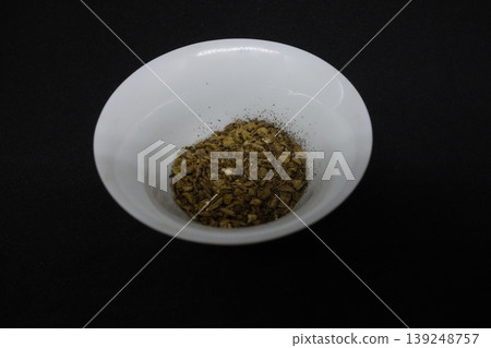 Dried Herbs in White Bowl on Black Background Dried Herbs in White Bowl on Black Background 139248757