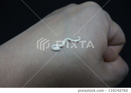 White Curved Object on Clenched Hand White Curved Object on Clenched Hand 139248760