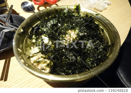 Seaweed and Rice Dish in Metal Bowl on Wooden Table Seaweed and Rice Dish in Metal Bowl on Wooden Table 139248828