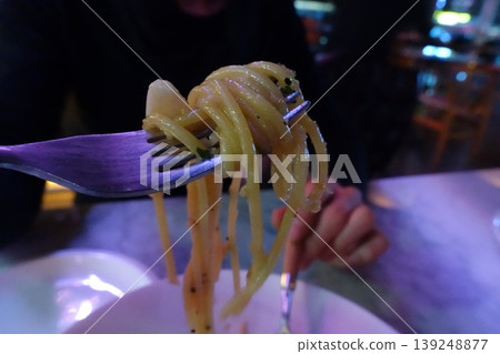 Fork with Pasta in Restaurant Setting 139248877