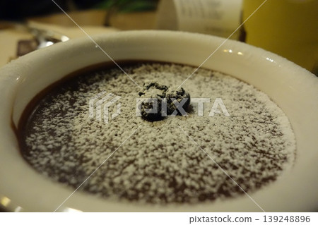 Chocolate Dessert with Powdered Sugar and Toppings 139248896