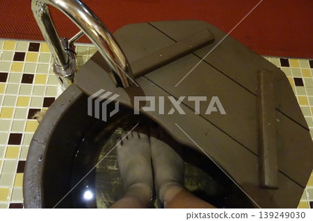 Feet in Foot Bath with Wooden Lid and Faucet Feet in Foot Bath with Wooden Lid and Faucet 139249030