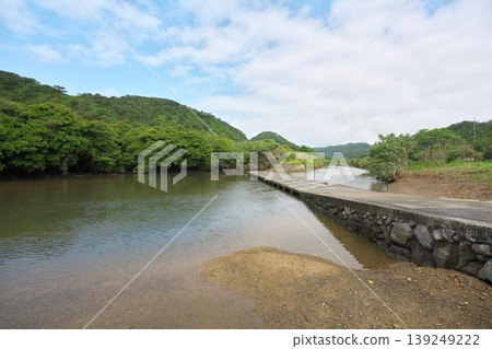 Okinawa, Nago, a submersible bridge over the Oura River, with a view towards the mangrove forest. Okinawa, Nago, a submersible bridge over the Oura River, with a view towards the mangrove forest. 139249222