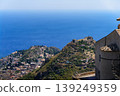 A view of the sea and the castle ruins on a hilltop from Taormina, Sicily, Italy. 139249359