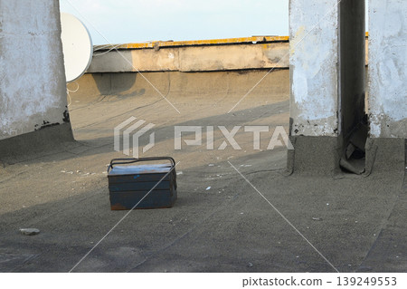 blue metal tool box stands on the roof of the building blue metal tool box stands on the roof of the building 139249553
