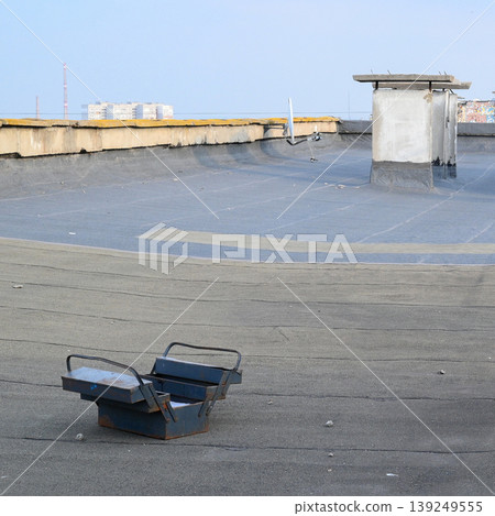 open blue metal tool box on a grey roof open blue metal tool box on a grey roof 139249555