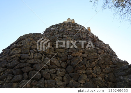 The castle's stone walls stand out against the clear blue sky. 139249663