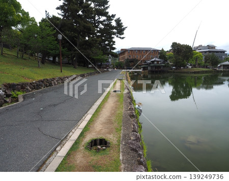 Walking along the edge of Sarusawa Pond under a cloudy sky. A historical landscape that evokes a sense of depth. Walking along the edge of Sarusawa Pond under a cloudy sky. A historical landscape that evokes a sense of depth. 139249736