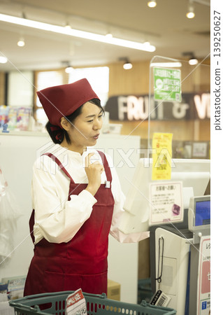 A staff member panics after making a mistake operating the cash register. A staff member panics after making a mistake operating the cash register. 139250627