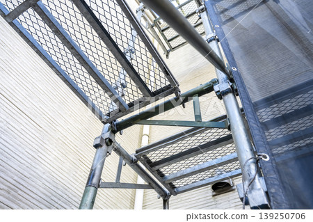 Old exterior walls and scaffolding of a detached house, immediately after construction began. Old exterior walls and scaffolding of a detached house, immediately after construction began. 139250706
