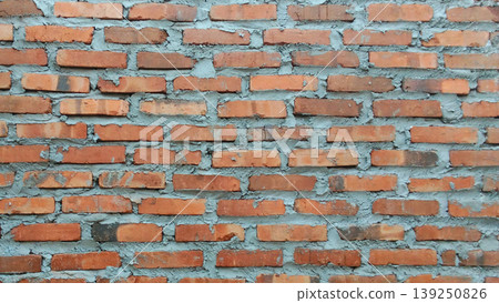 Traditional red brick wall texture with rough cement mix. 139250826