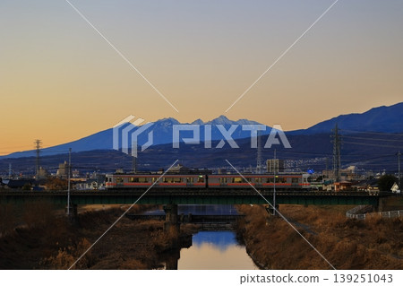 The Minobu Line crossing the Arakawa River and the Yatsugatake Mountains in the evening. The Minobu Line crossing the Arakawa River and the Yatsugatake Mountains in the evening. 139251043
