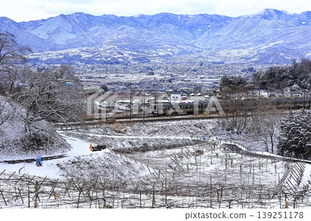 The Chuo Line train travels through snow-covered Katsunuma. The Chuo Line train travels through snow-covered Katsunuma. 139251178