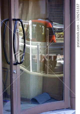 A car reflected in the entrance glass. A car reflected in the entrance glass. 139251337