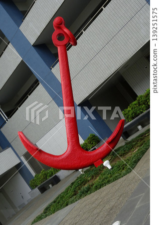 An anchor motif displayed amidst the buildings of the city. An anchor motif displayed amidst the buildings of the city. 139251575