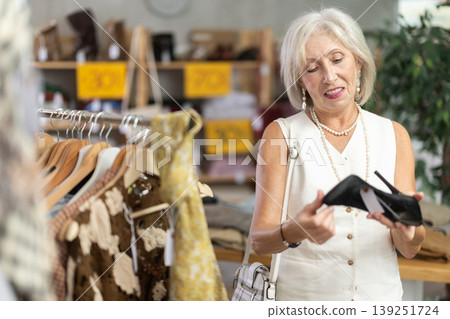 Elderly women choosing high heel shoes in store 139251724