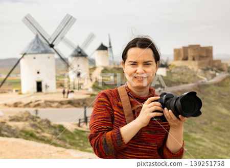 Woman tourist takes pictures of the windmills of city of Consuegra. Spain 139251758