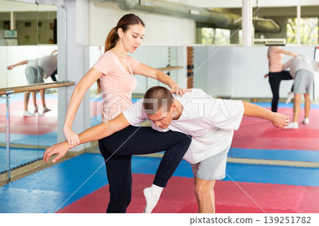 Young woman exercising knee strike during self-protection training Young woman exercising knee strike during self-protection training 139251782